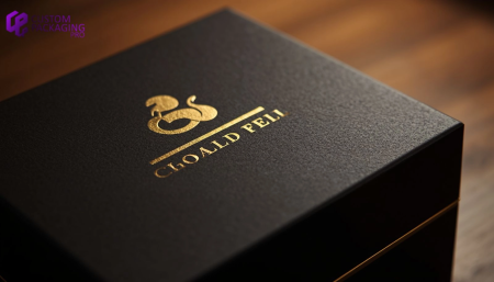 Luxury matte black packaging box with reflective gold foil stamped logo under professional studio light