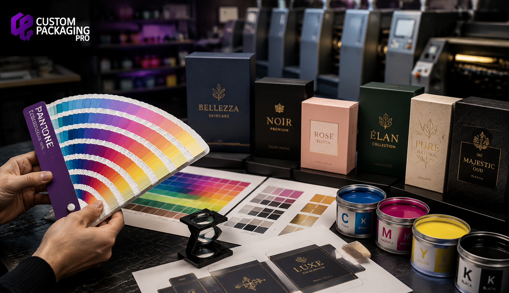 Pantone PMS printing color guide with luxury packaging boxes, CMYK ink cans, and print color swatches in a professional packaging printing studio
